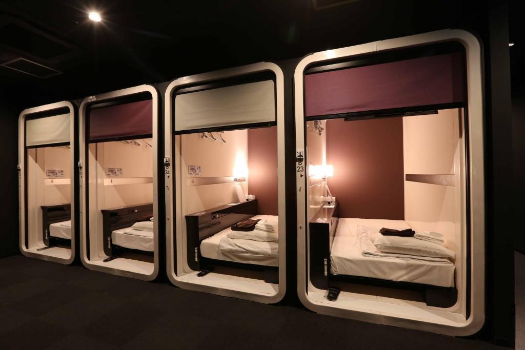 A cabin doorway and folded linen on a corridor at First Cabin Hakata