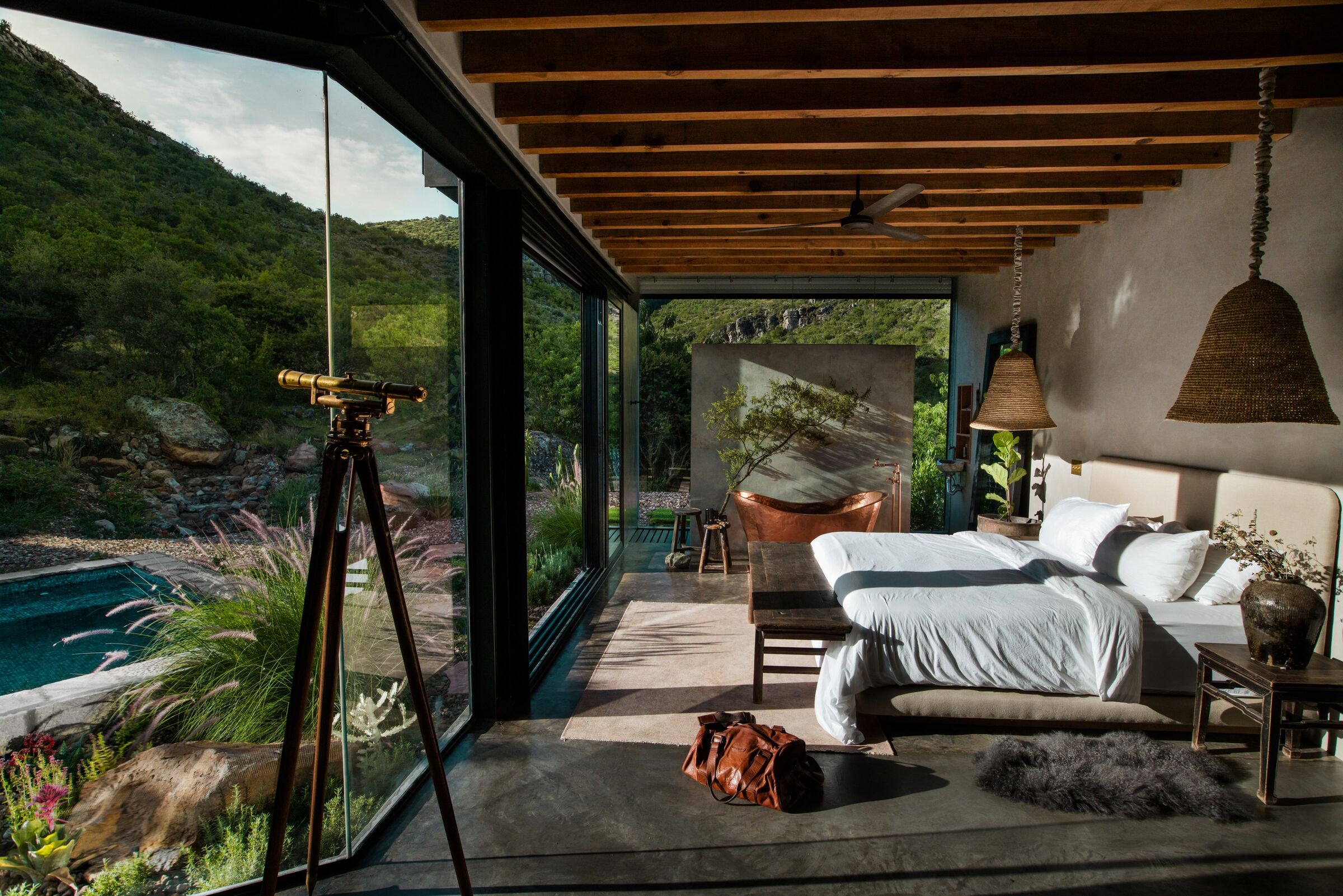 A mirrored house on a volcanic hillside above Guanajuato with a footpath approaching it